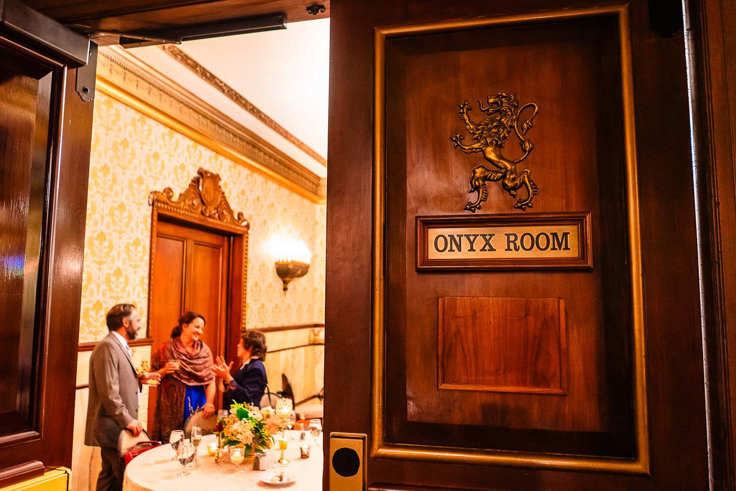 Elegant dining scene inside the Onyx Room of the Brown Palace with guests engaged in conversation.