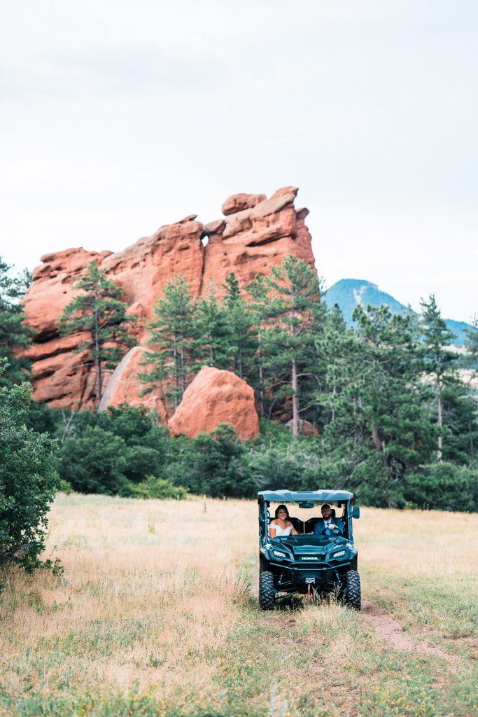 groom drives his bride in a UTV during their Larkspur elopement