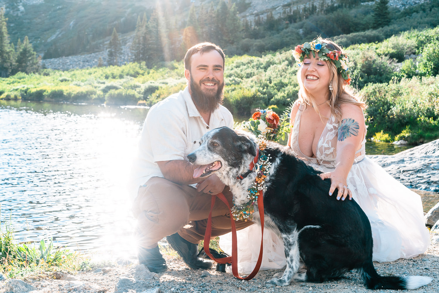 bride and groom with their dog next to the shore of Blue Lakes in Breckenridge Colorado during their mountain wedding