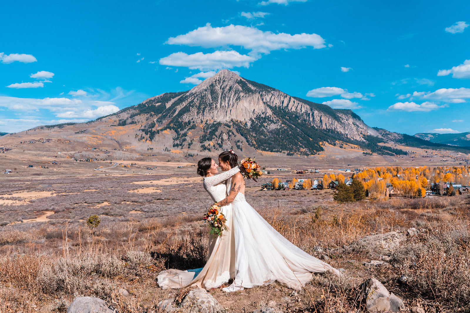 Newlyweds embrace beneath Mount Crested Butte in one of the best places to elope in Colorado.