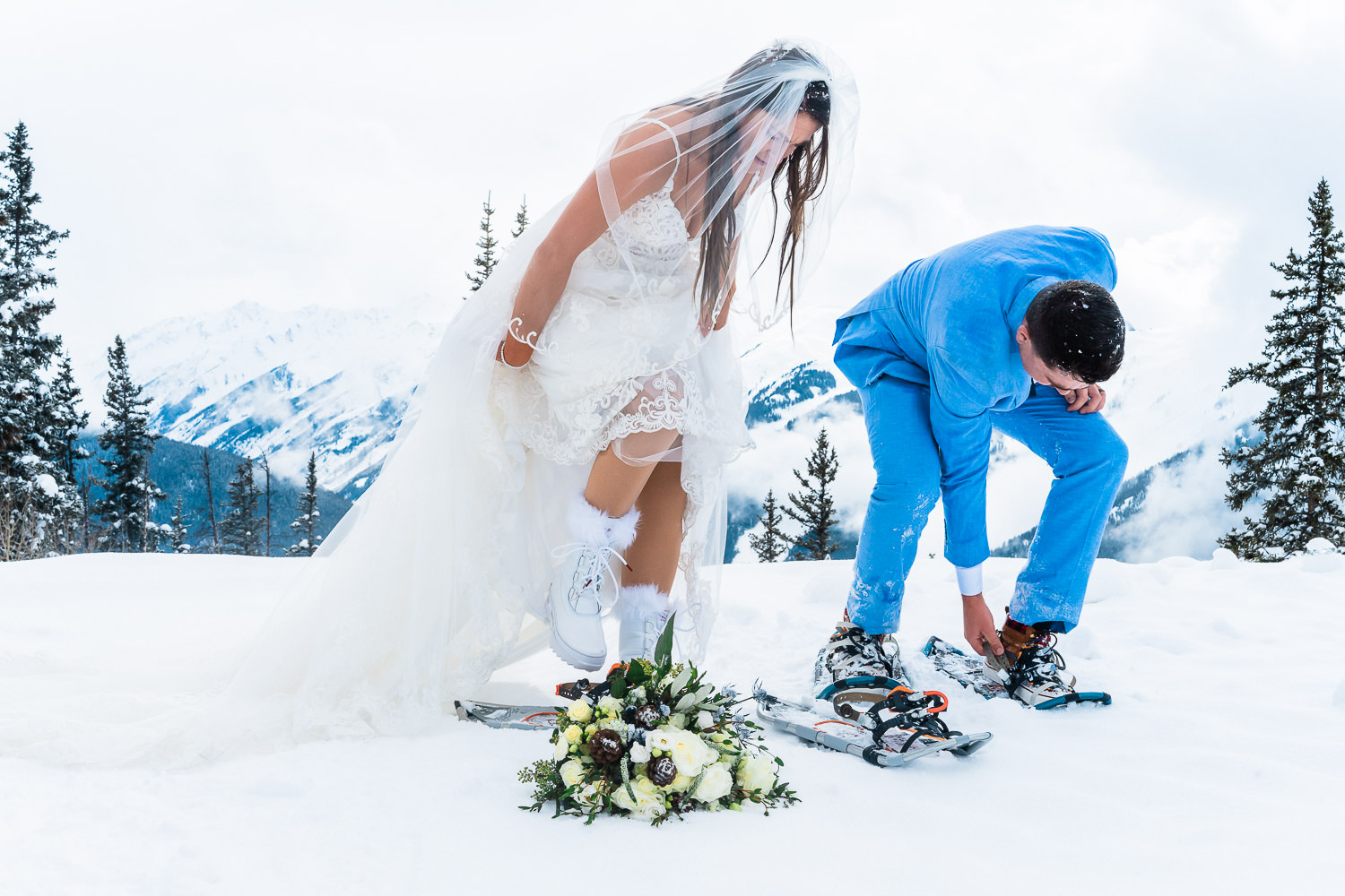 Newlyweds snowshoe in the mountains