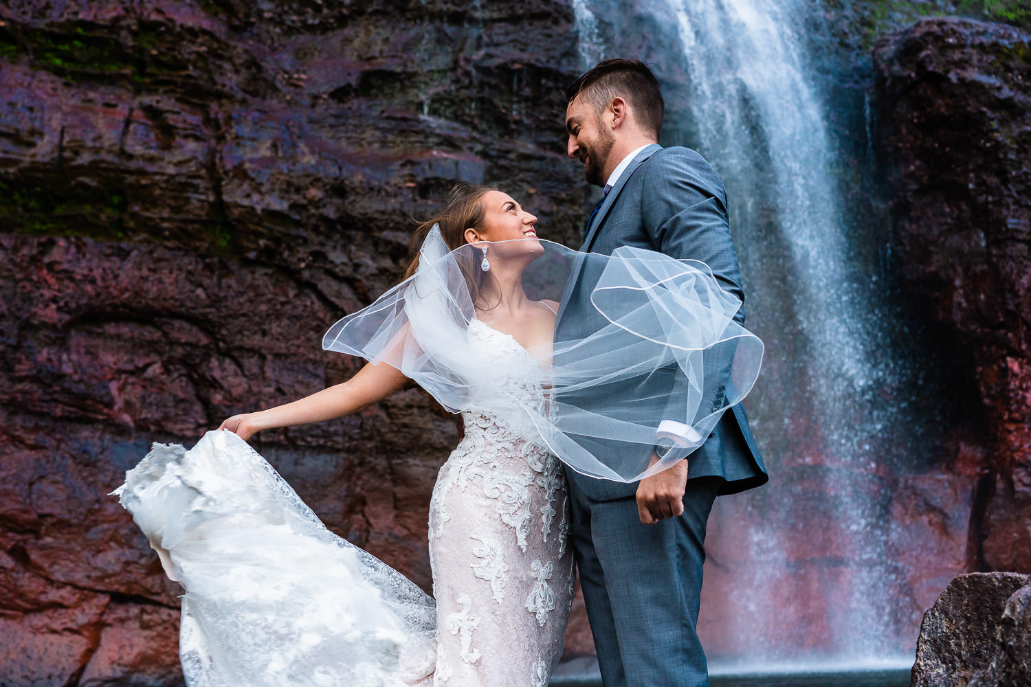 A couple eloping beneath a Colorado waterfall