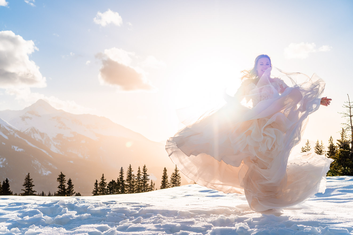 newly wed bride on a snow covered mountain