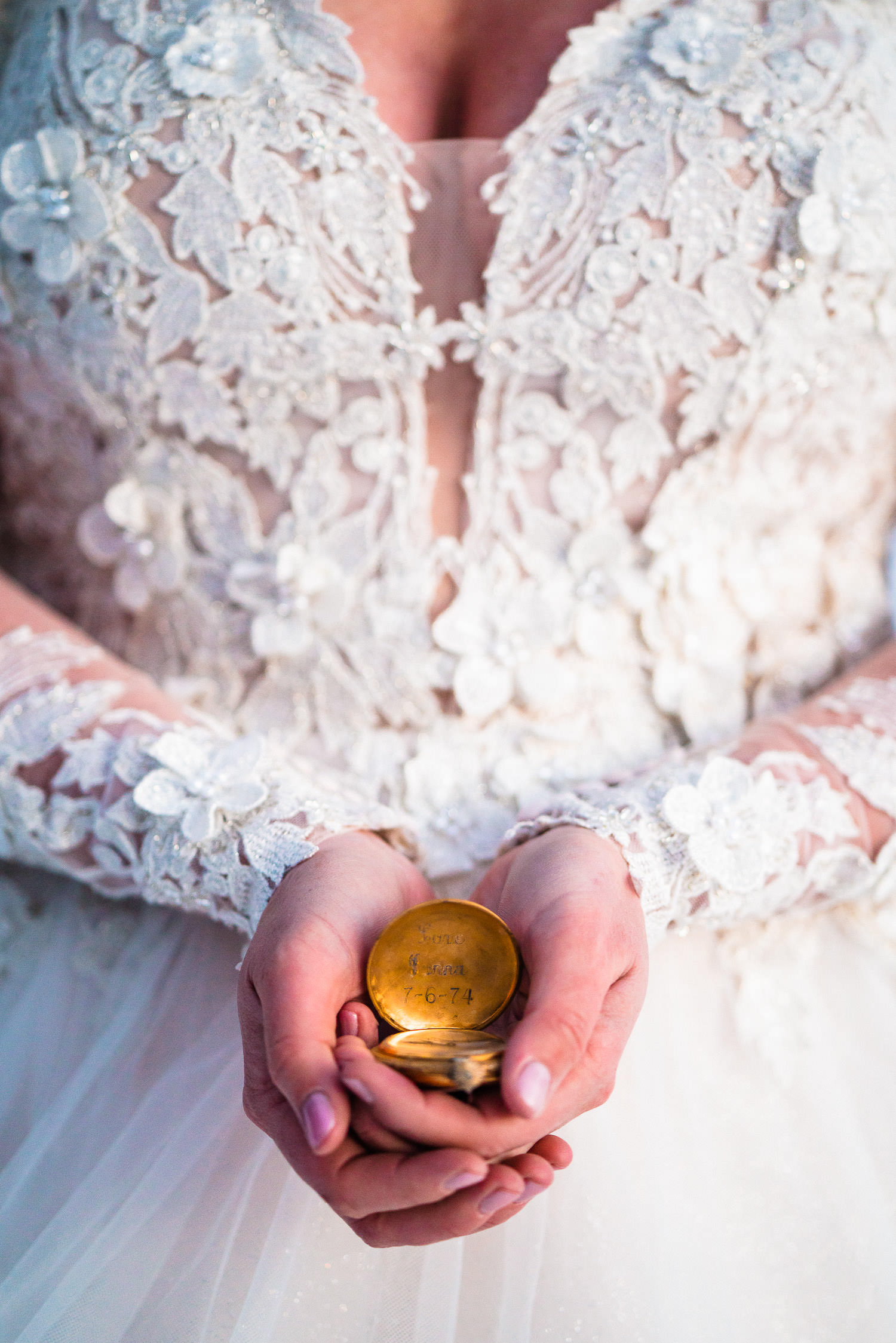 newly wed bride holds a sentimental pocket watch