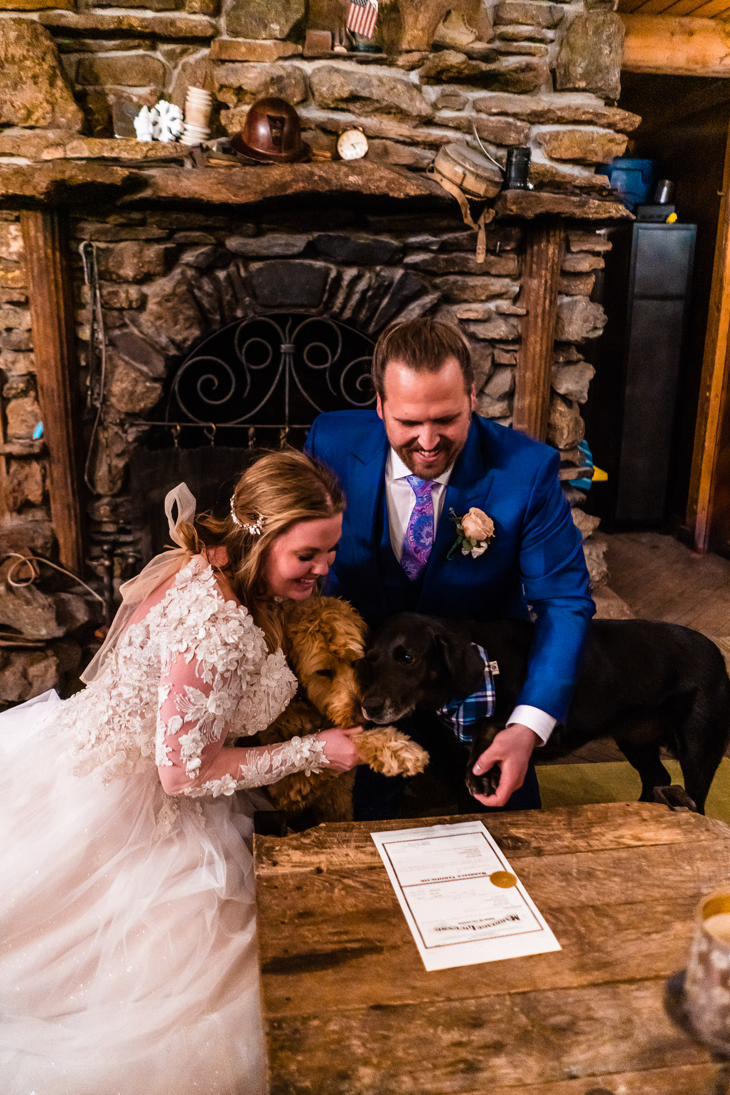 newlyweds sign their Colorado marriage license with their dogs