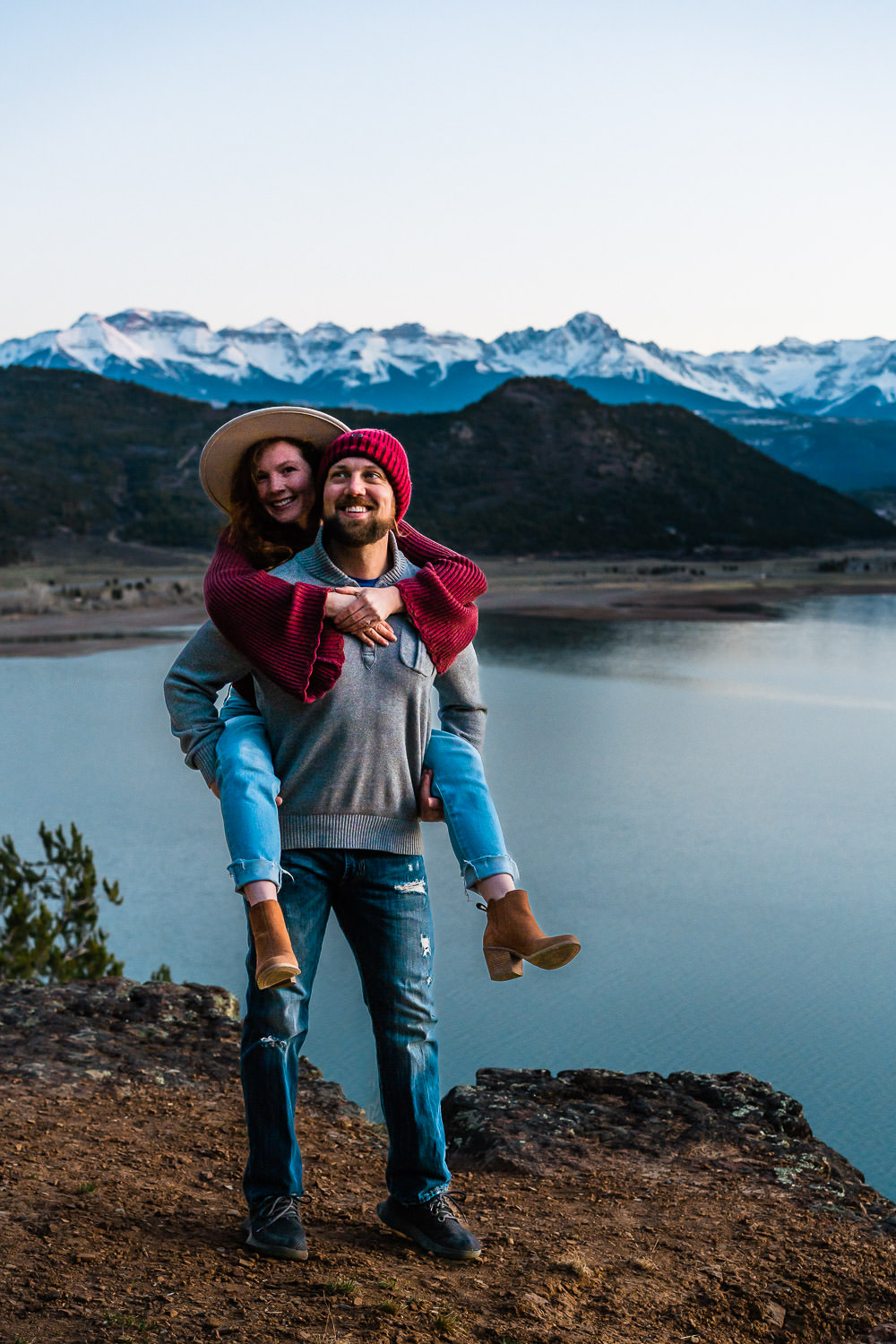 Colorado Elopement Photographers Meg and Kevin exploring a mountain lake during sunset