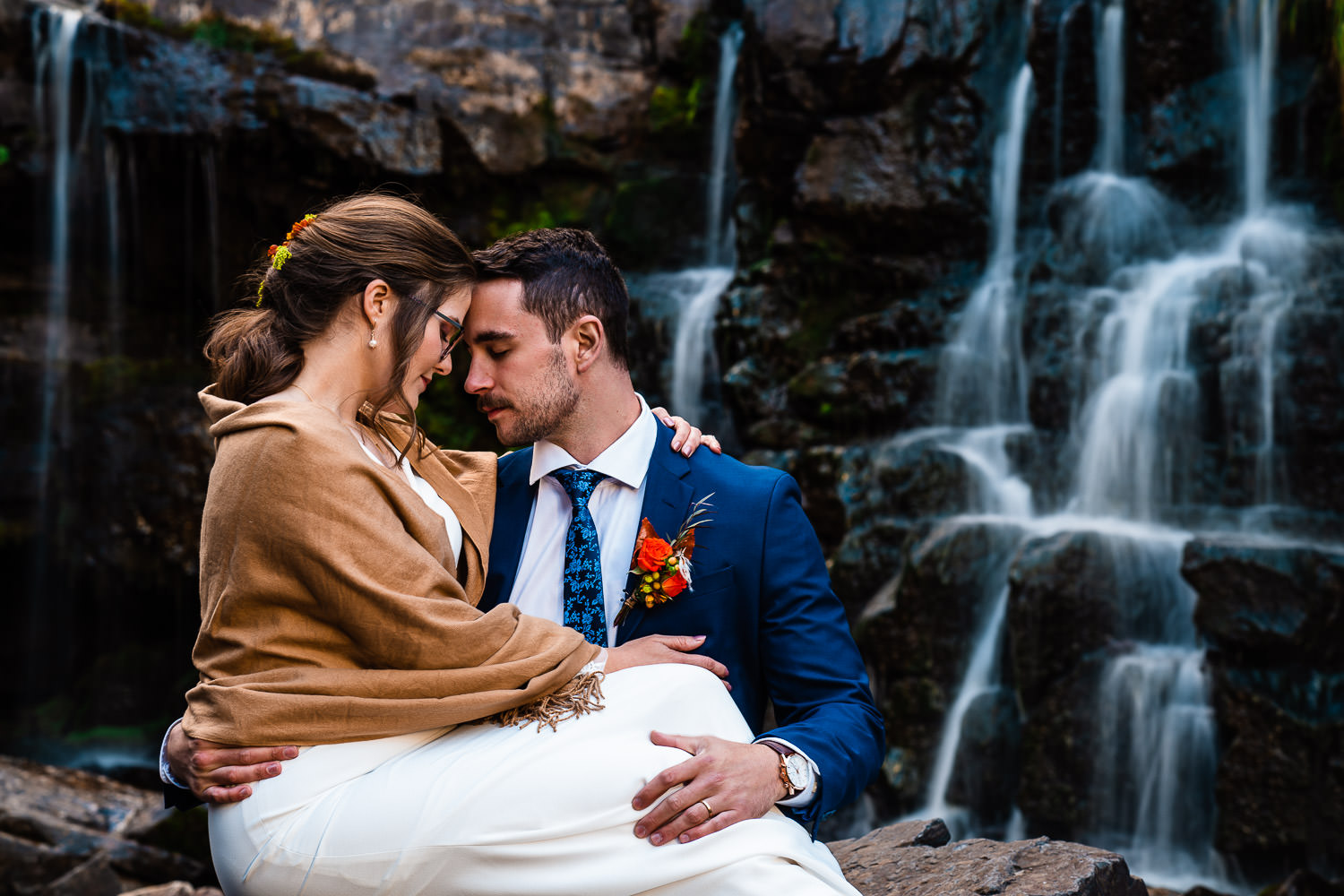 newlyweds at a waterfall