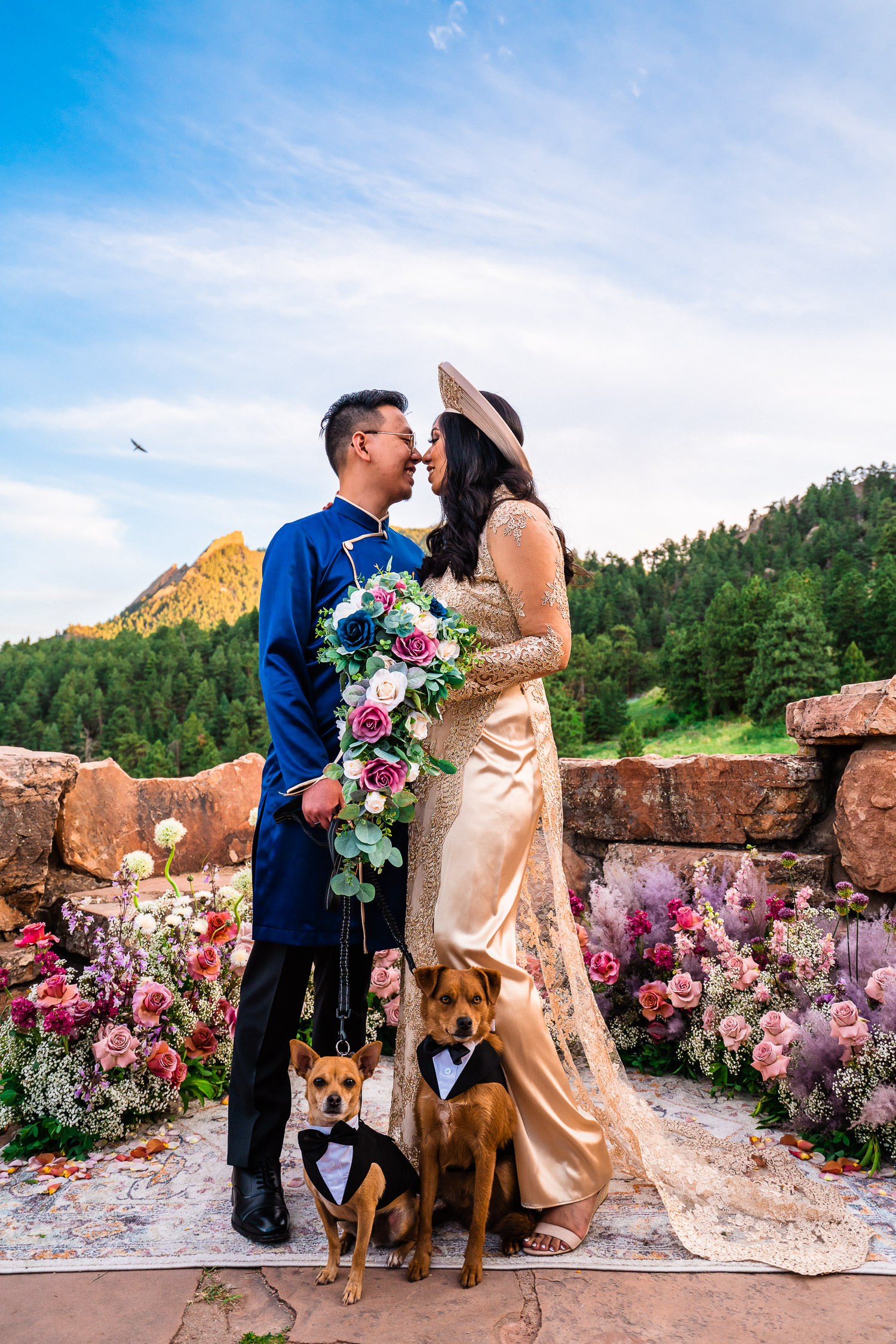newlyweds and their pups with flowers