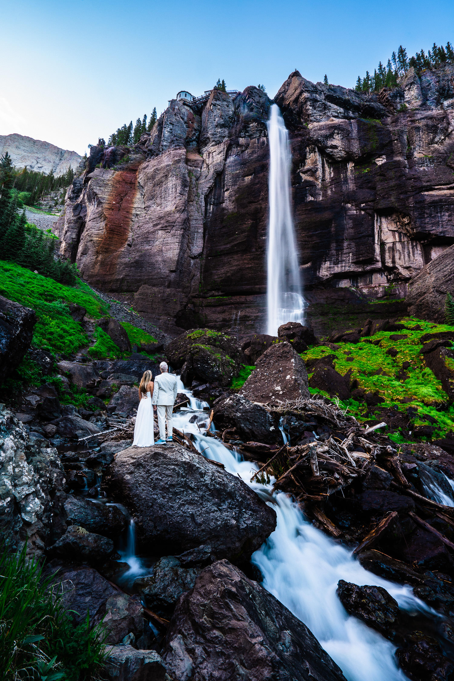 newlyweds by a waterfall Colorado Elopement Photographer