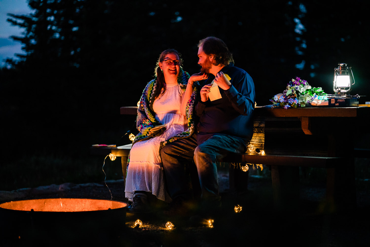 newlyweds near a campfire