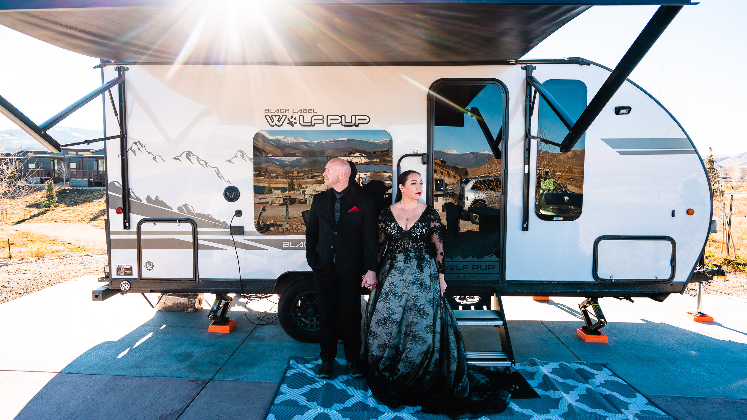 Camping Elopement Couple in Wedding Attire infront of RV