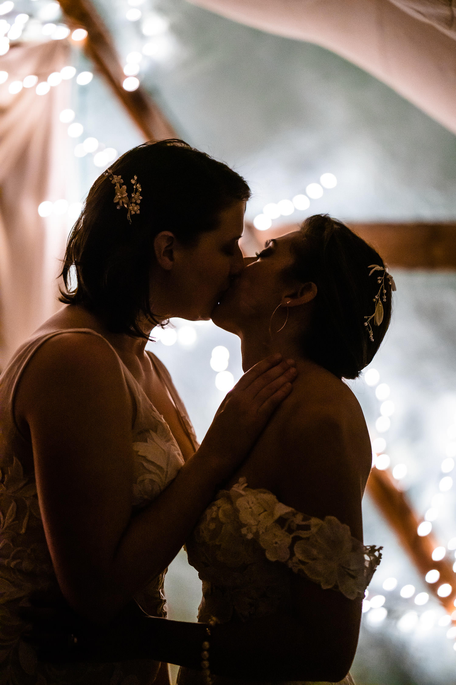 newlywed brides sharing a sweet kiss