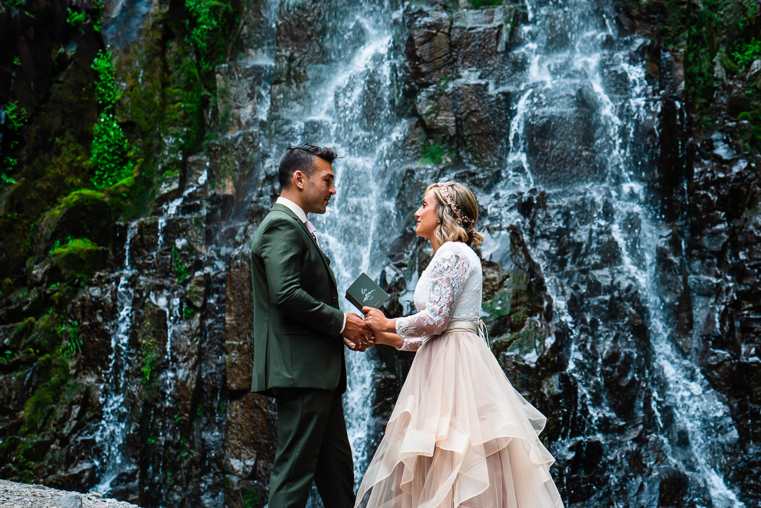 Bride and groom self solemnizing beneath a 70 foot Colorado waterfall