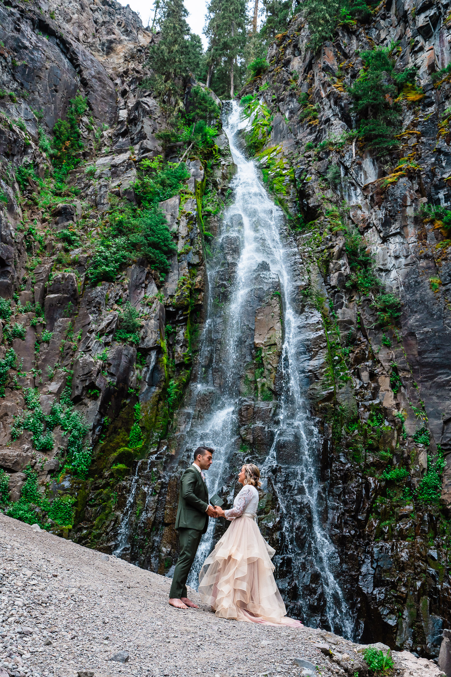 Bride and groom self solemnizing beneath a 70 foot Colorado waterfall