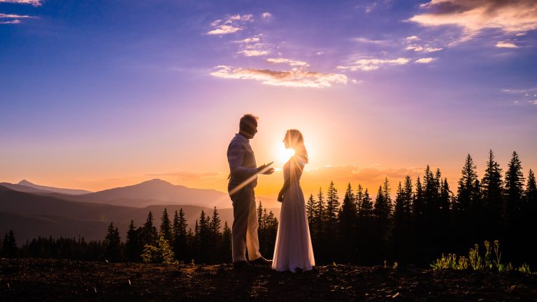 Bride and groom self solemnizing their marriage in the Colorado mountains at sunset
