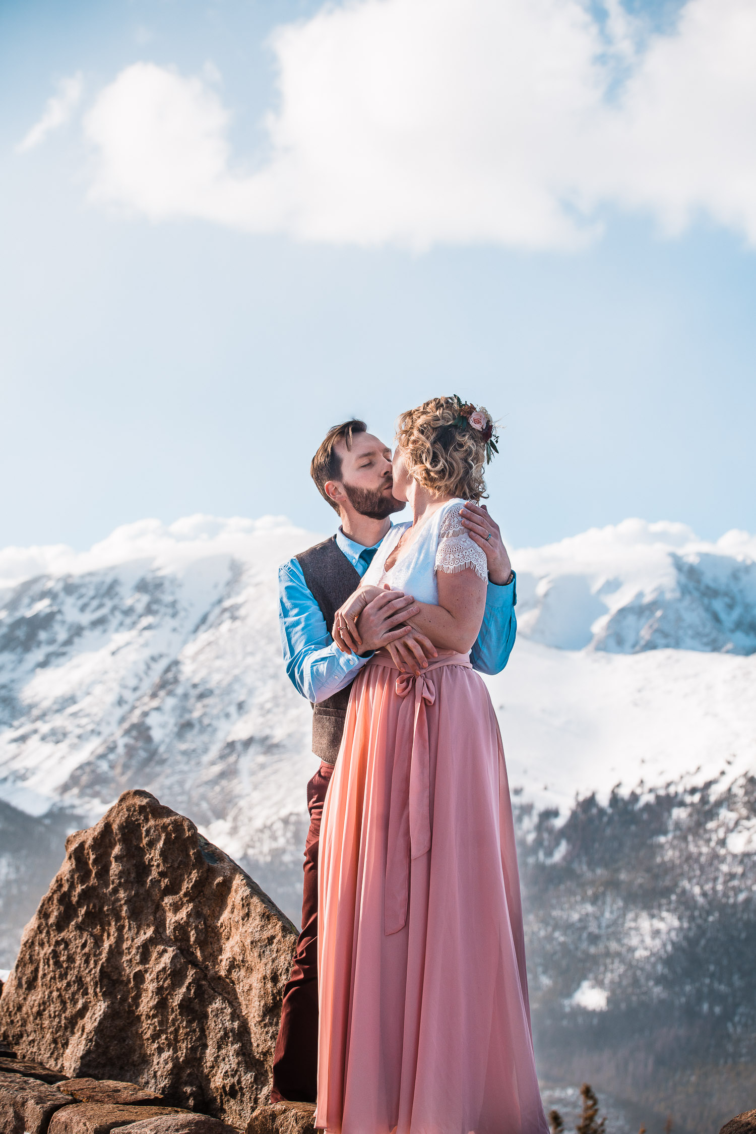 newlyweds embrace in the mountains during their Colorado winter elopement