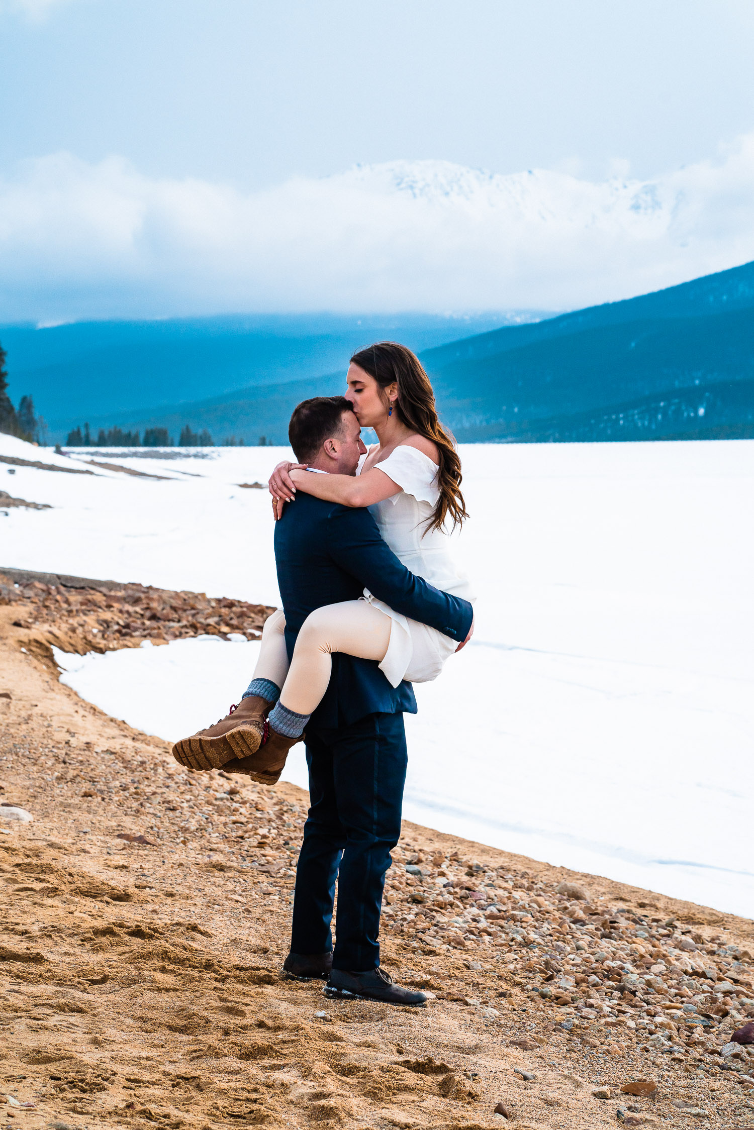 newlyweds embrace during their Colorado winter elopement