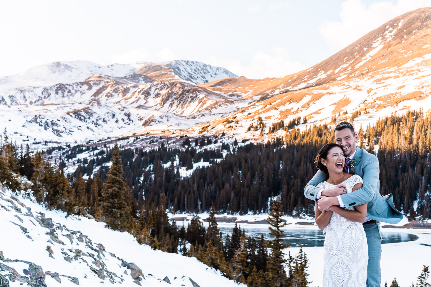 newlyweds embracing and laughing during their Colorado winter elopement