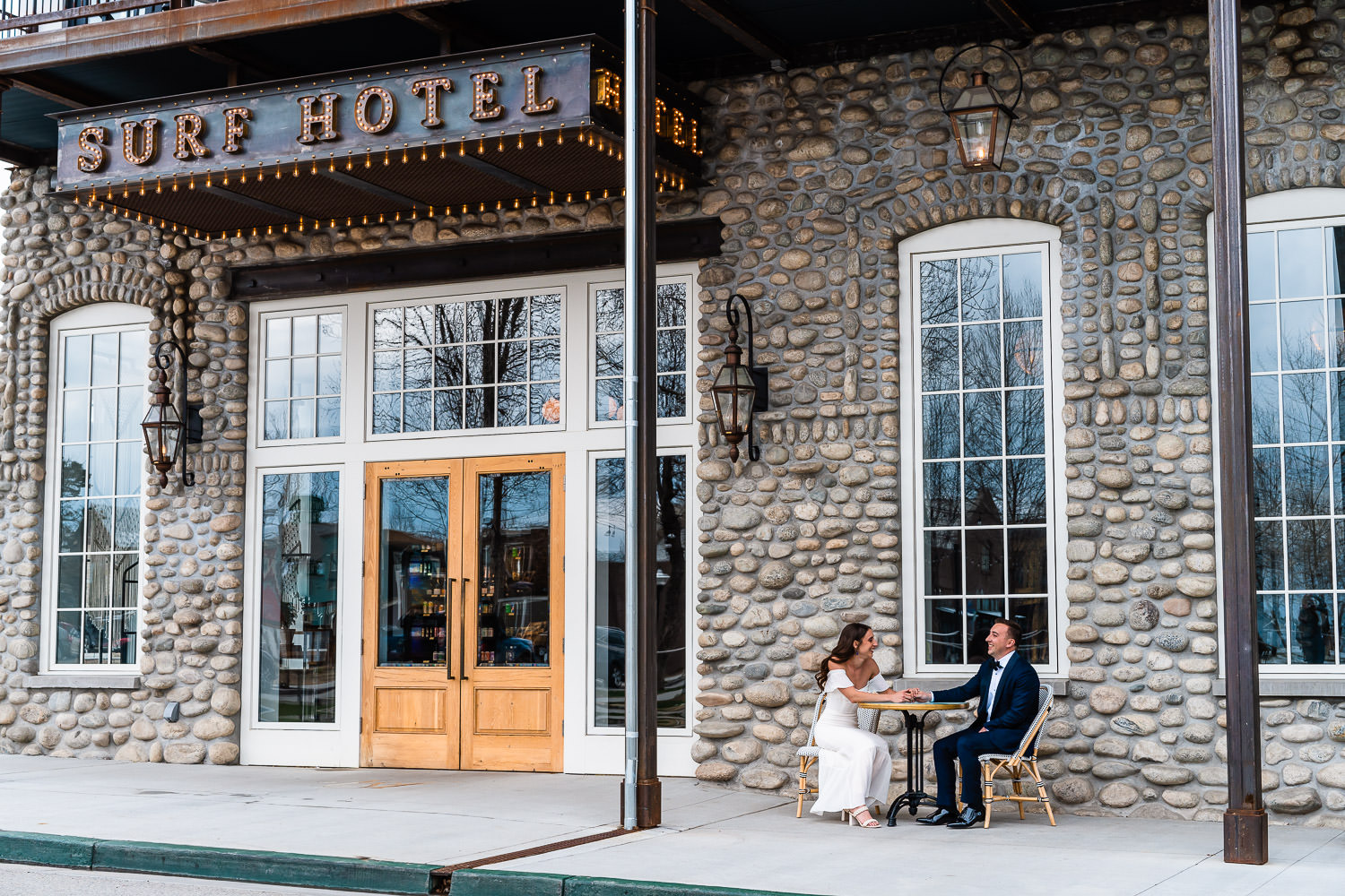 newlyweds sit outside of The Surf Hotel during their Buena Vista elopement