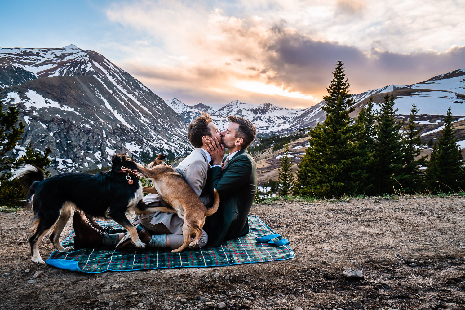 Two grooms kissing at sunset overlooking the mountain at Hoosier Pass Breckenridge Colorado