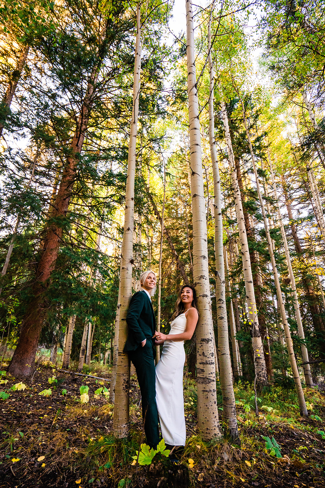 Adventurous Lesbian Elopement at Crested Butte in the mountains surrounded by towering trees