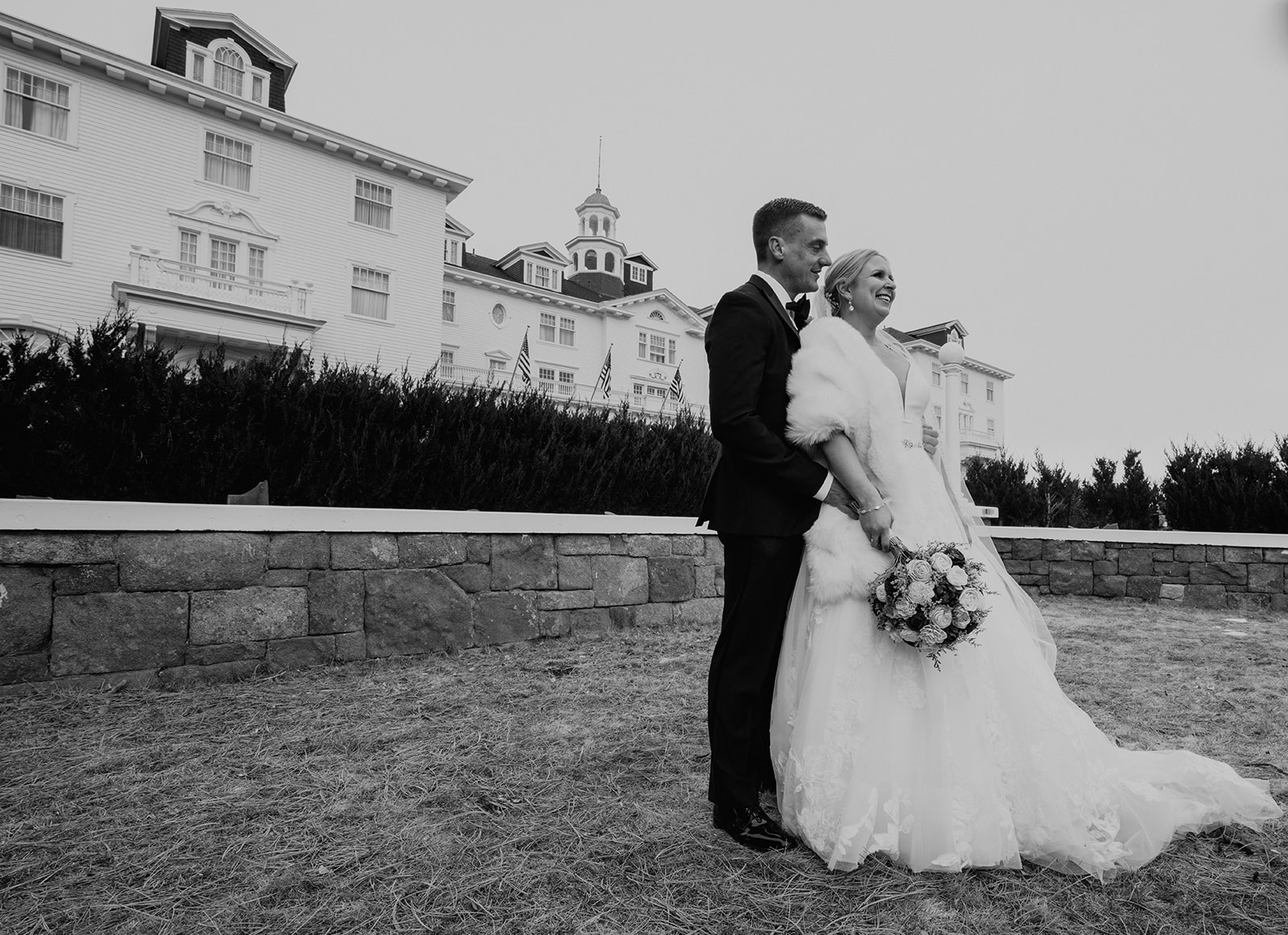 Beautiful bride and groom posing in front of the Stanley Hotel in Estes Park