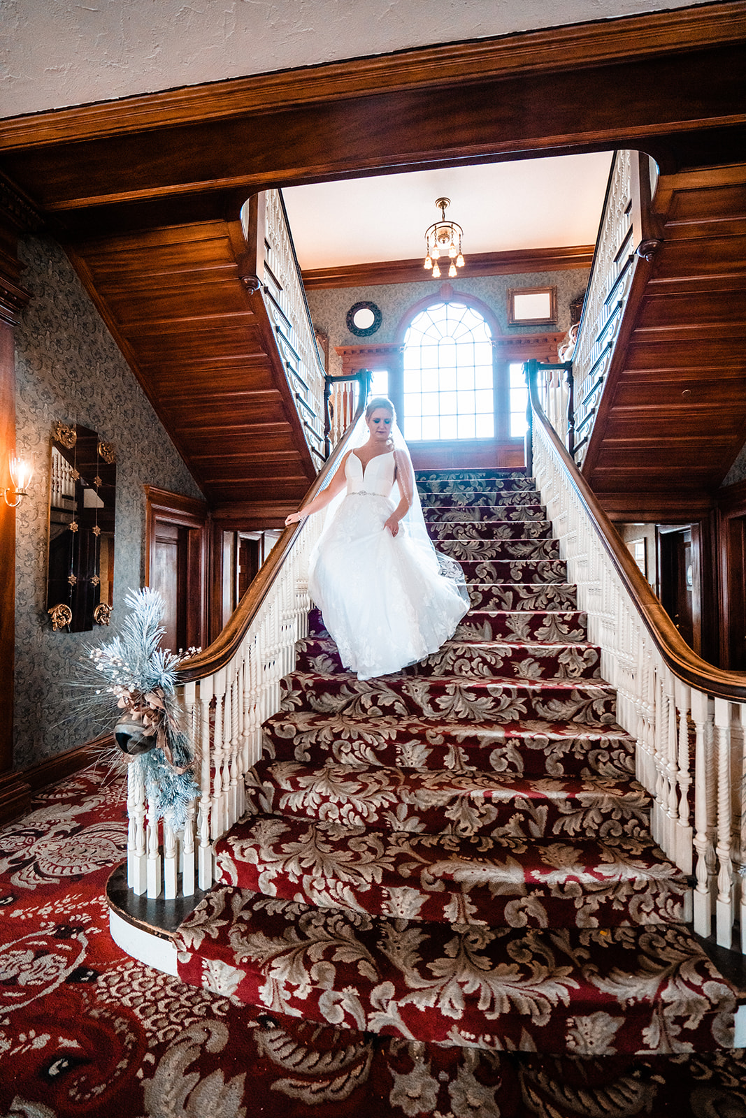 Bride walking down the stairs of the Stanley Hotel in Estes Park