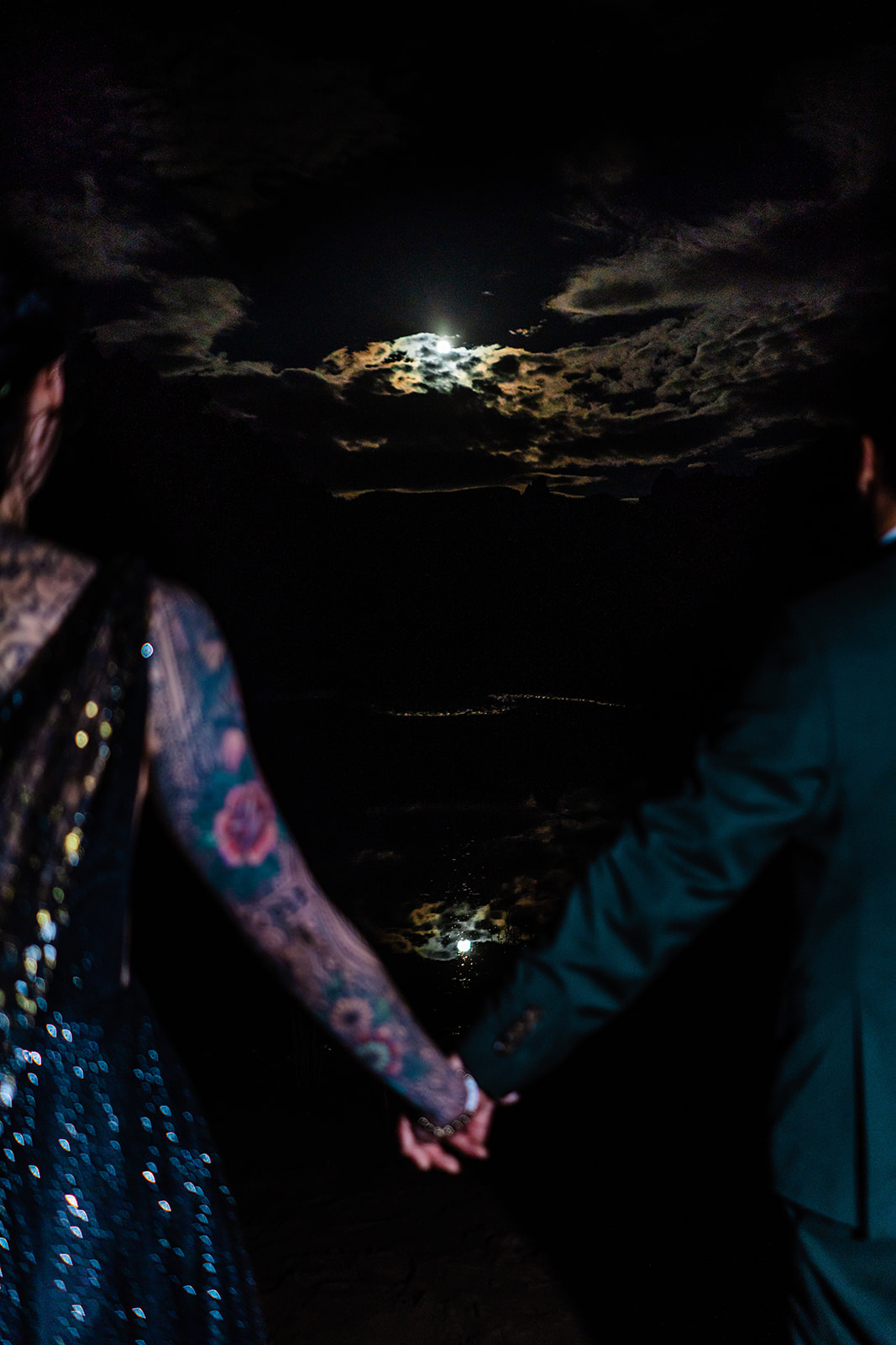 Bride and groom holding hands in spooky attire