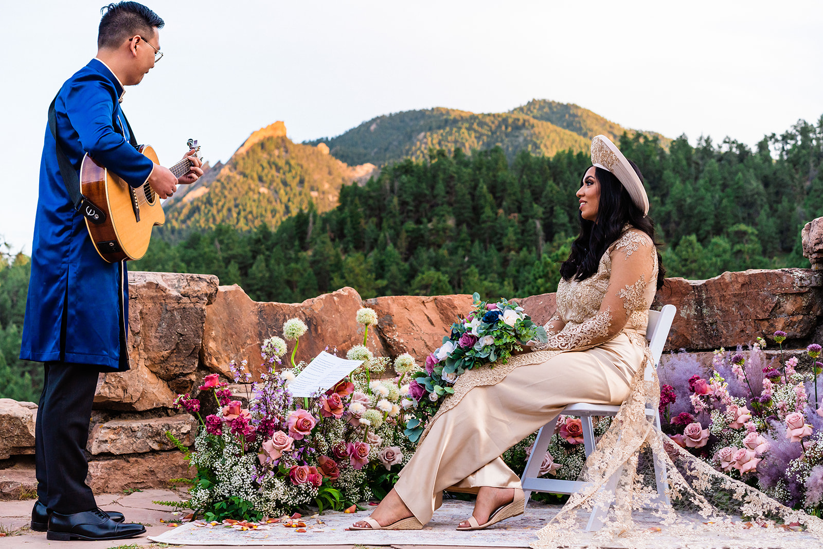 Groom serenading bride in front of Boulder Colorados beautiful mountains
