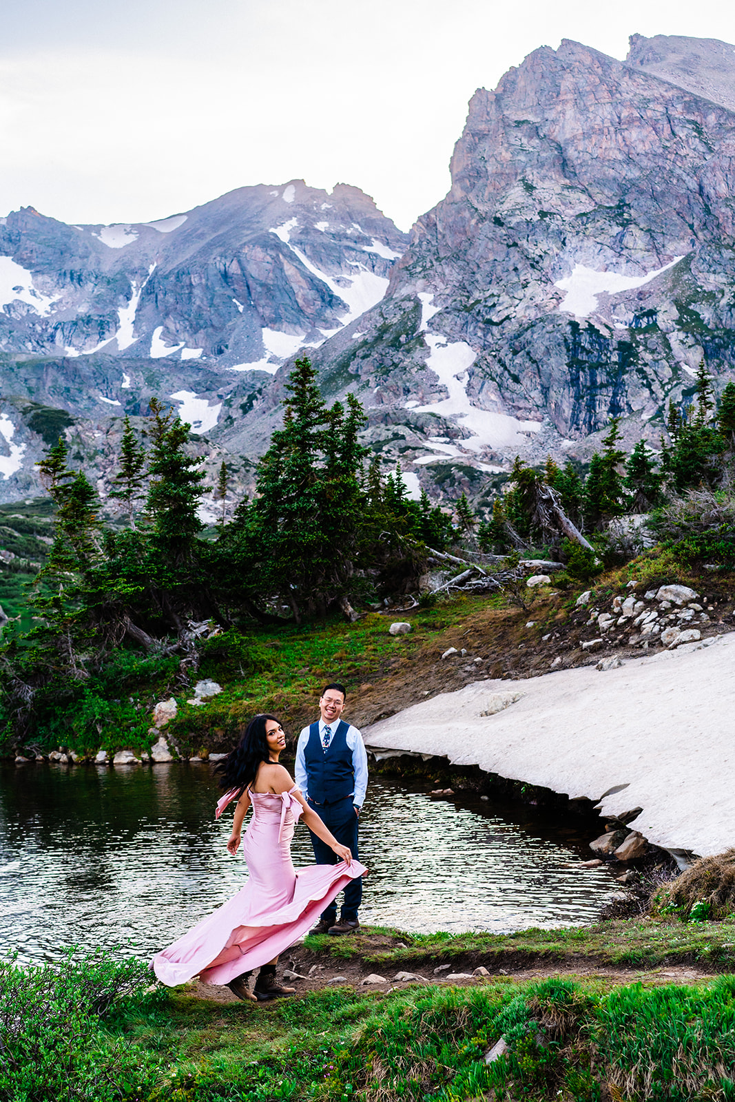 Bride and groom dancing in front of Lake Isabelle