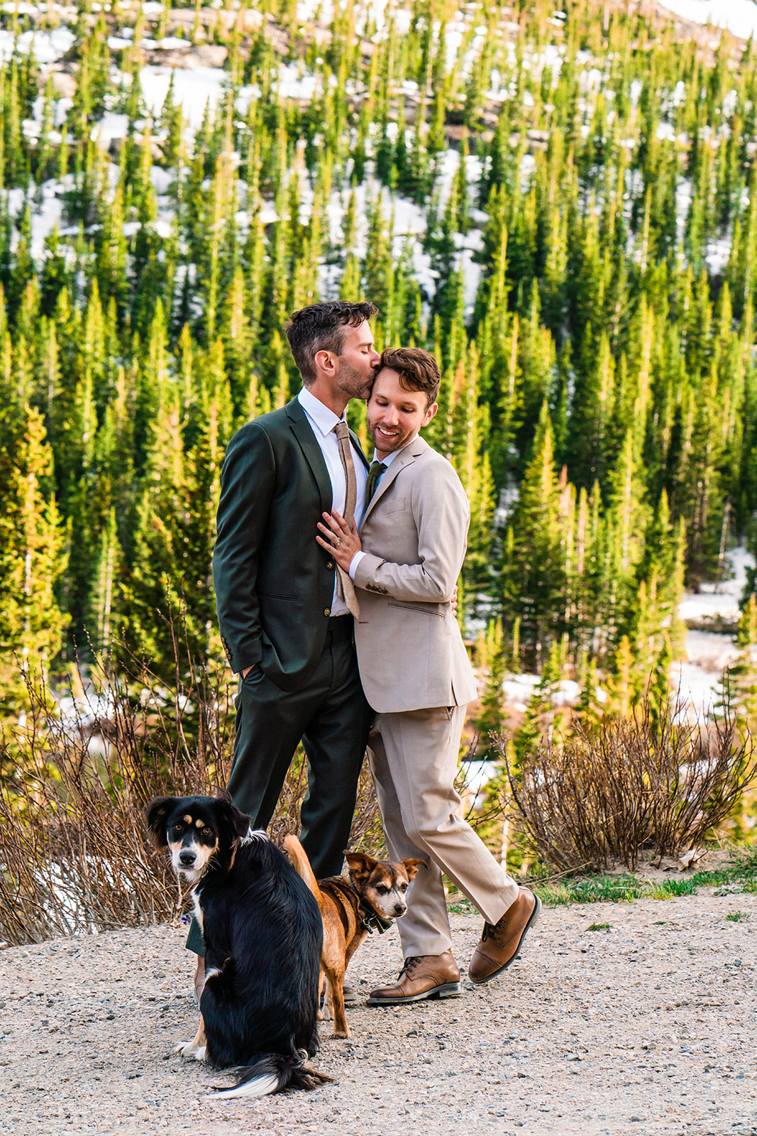 Gay couple smiling hugging one another in the Colorado mountains