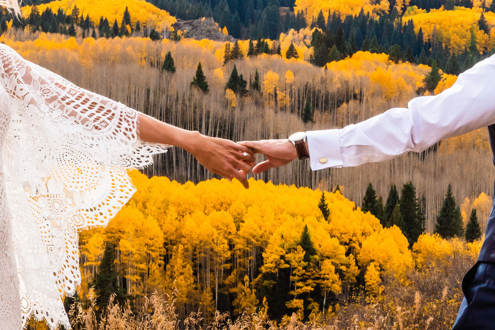 Couple holding hands during their Crested Butte Elopement in the fall