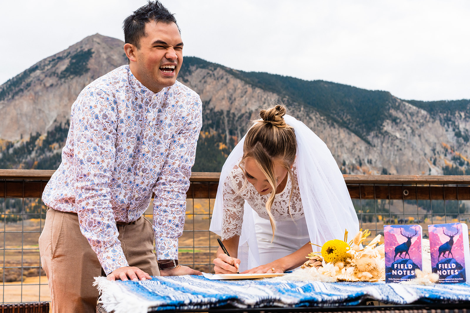 Couple signing their Marriage license for their Fall elopement at Crested Butte, Colorado with their dog
