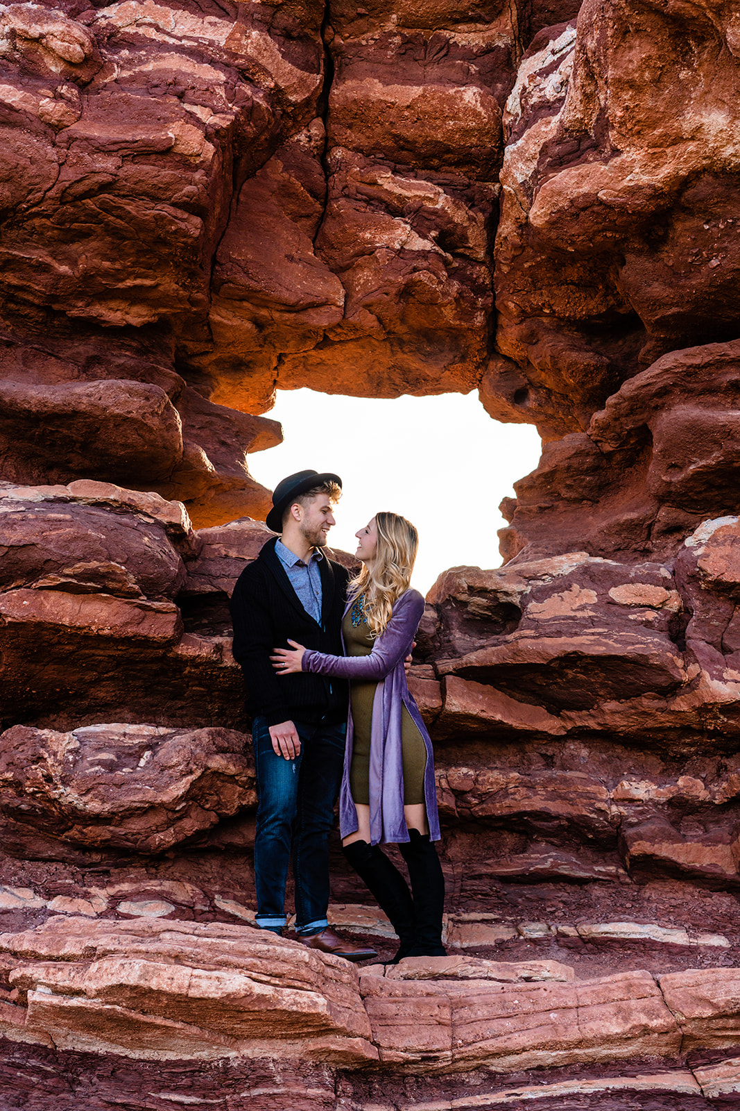 Adorable couple smiling and holding one another at the Garden of the Gods