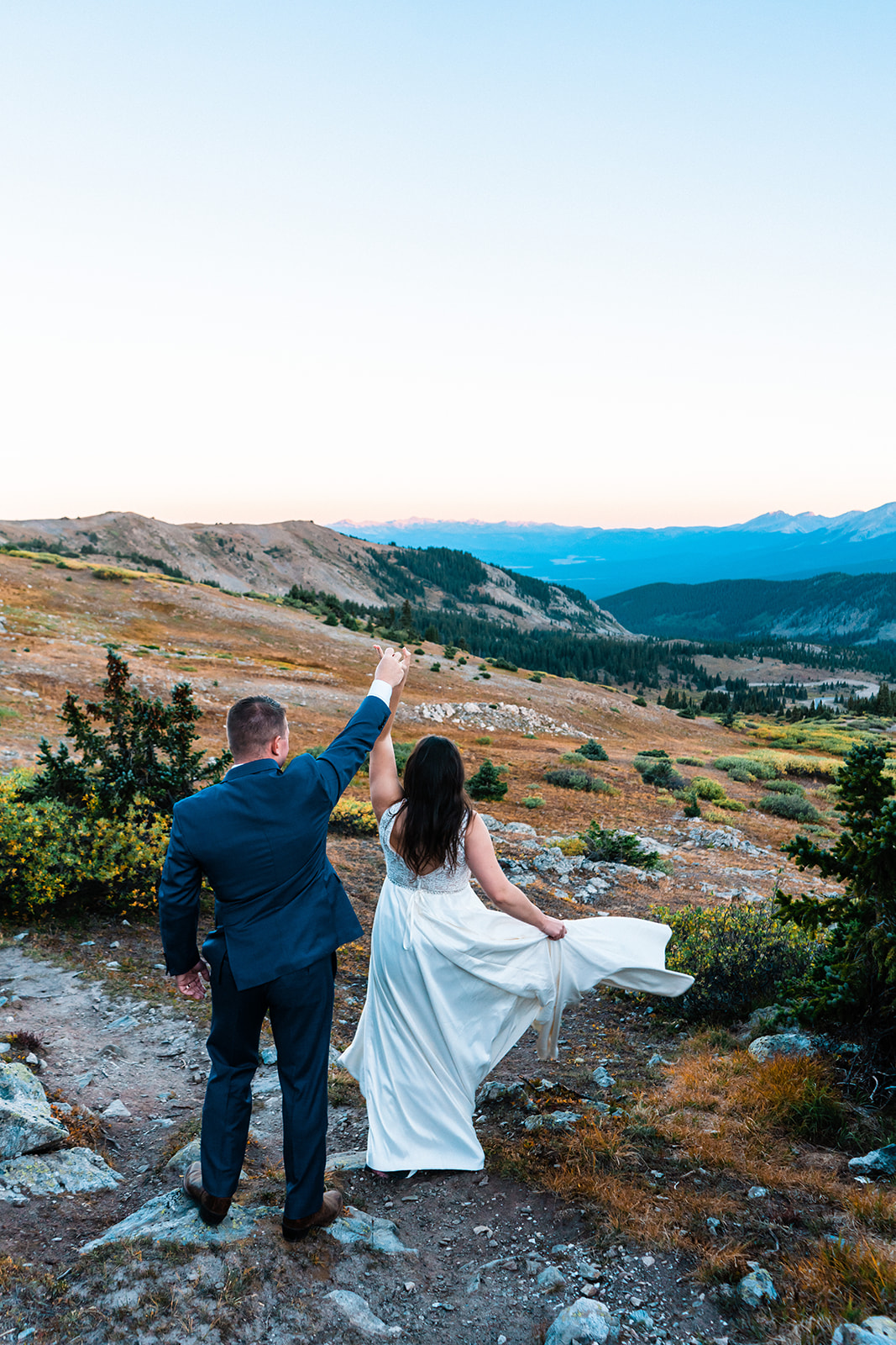 Bride and groom dancing during sunrise in the mountains of Colorado