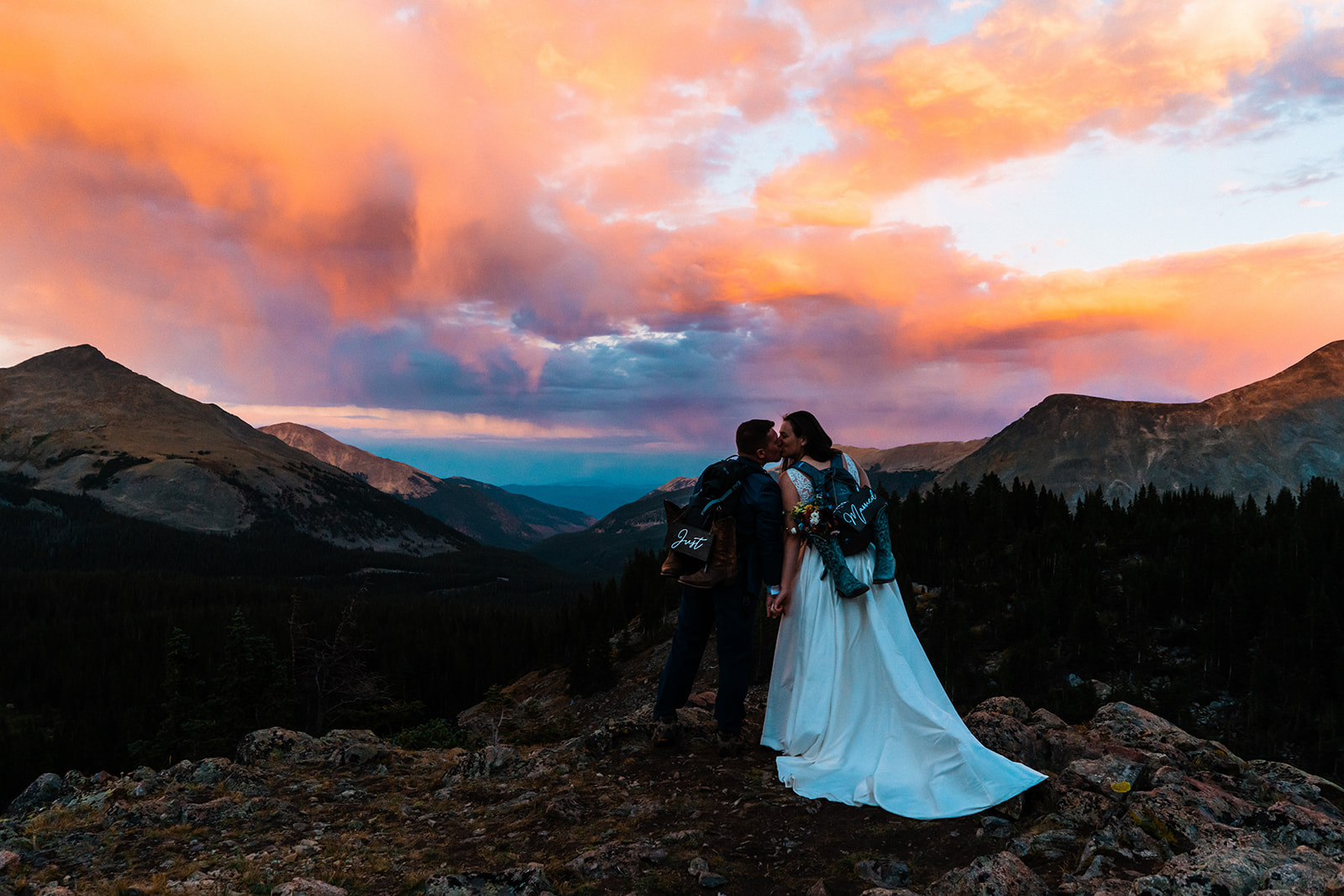 Bride and groom kissing during sunset