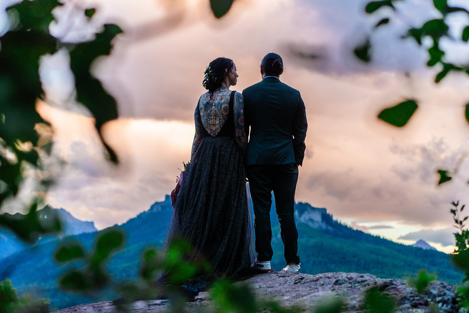 Bride and groom looking off into the distance at the Colorado Mountains