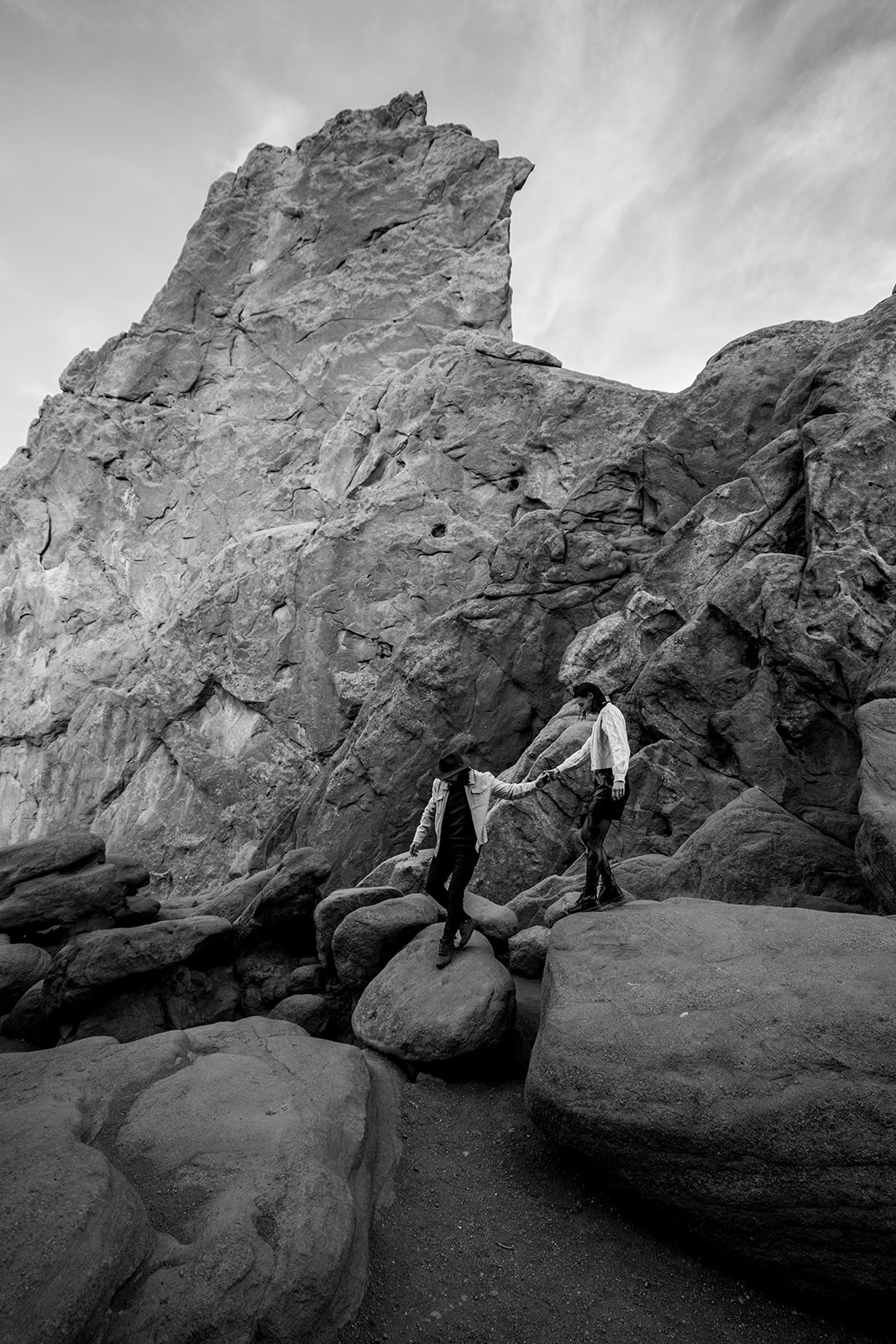 Newly engaged couple exploring the garden of the gods in black and white