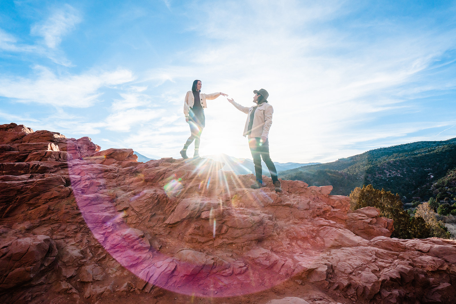 Newly engaged couple holding hands at the Garden of the Gods during sunset