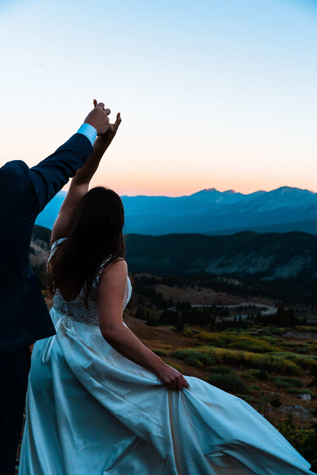 Bride and groom dancing during sunset