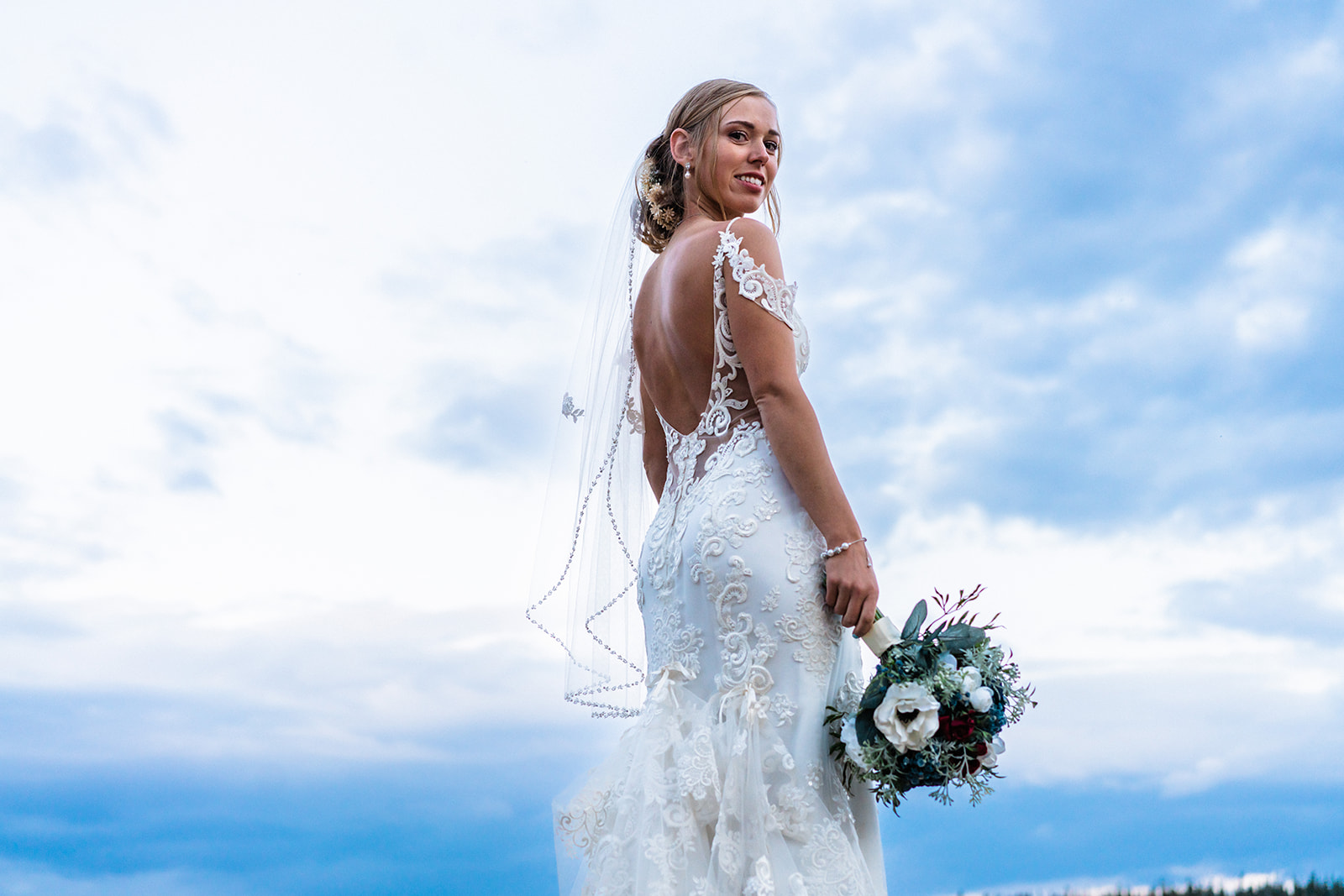 Bride posing in a white wedding dress