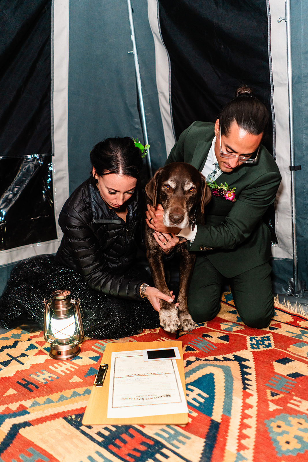 Black and white photo of bride and grooms pup signing their marriage license