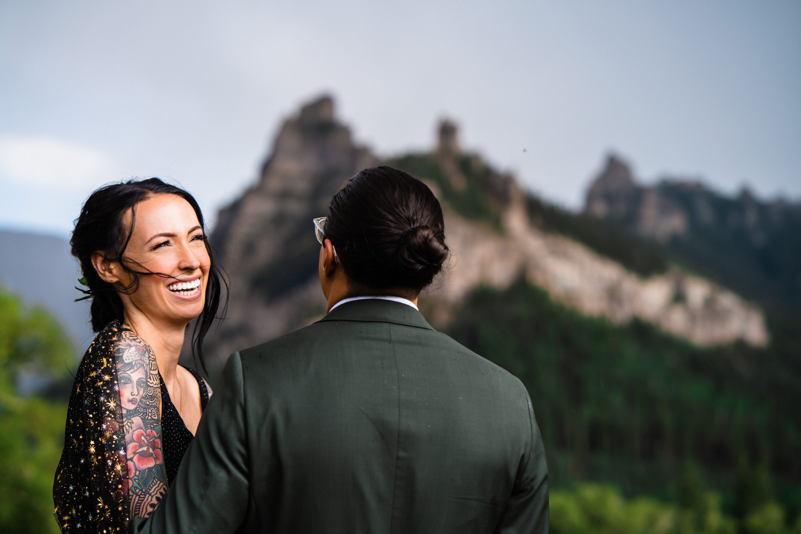 Bride laughing and smiling at groom during their celestial themed elopement