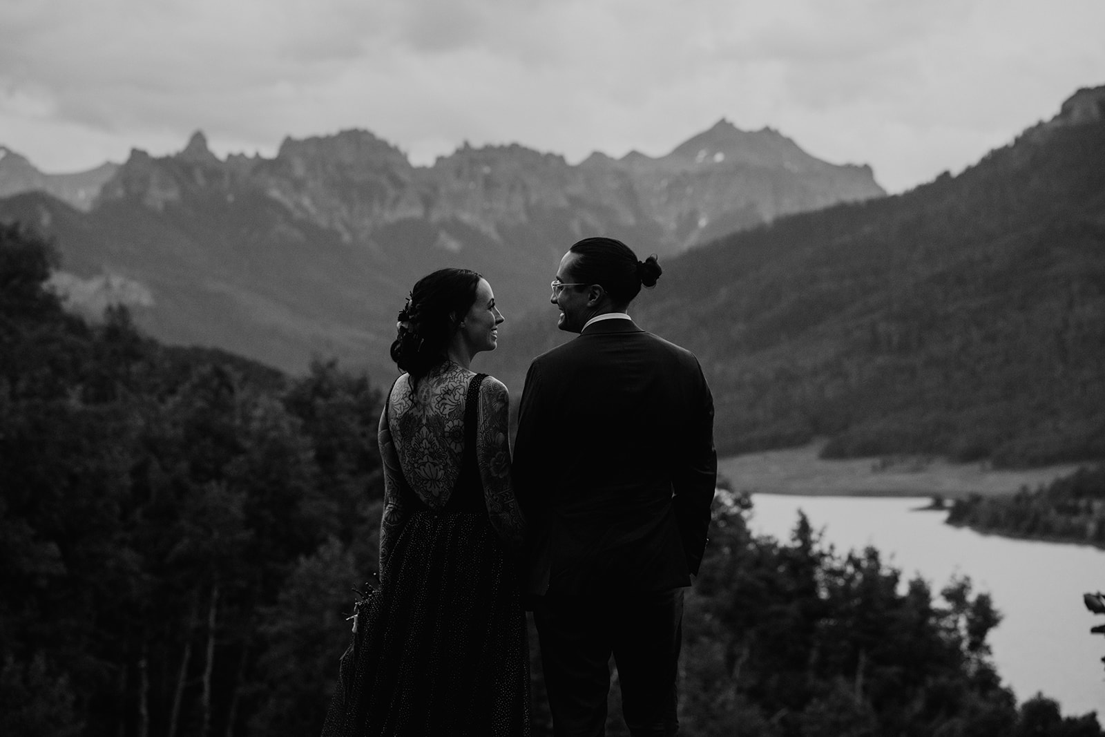 Black and white photo of Bride and groom looking at one another in the mountains of Colorado