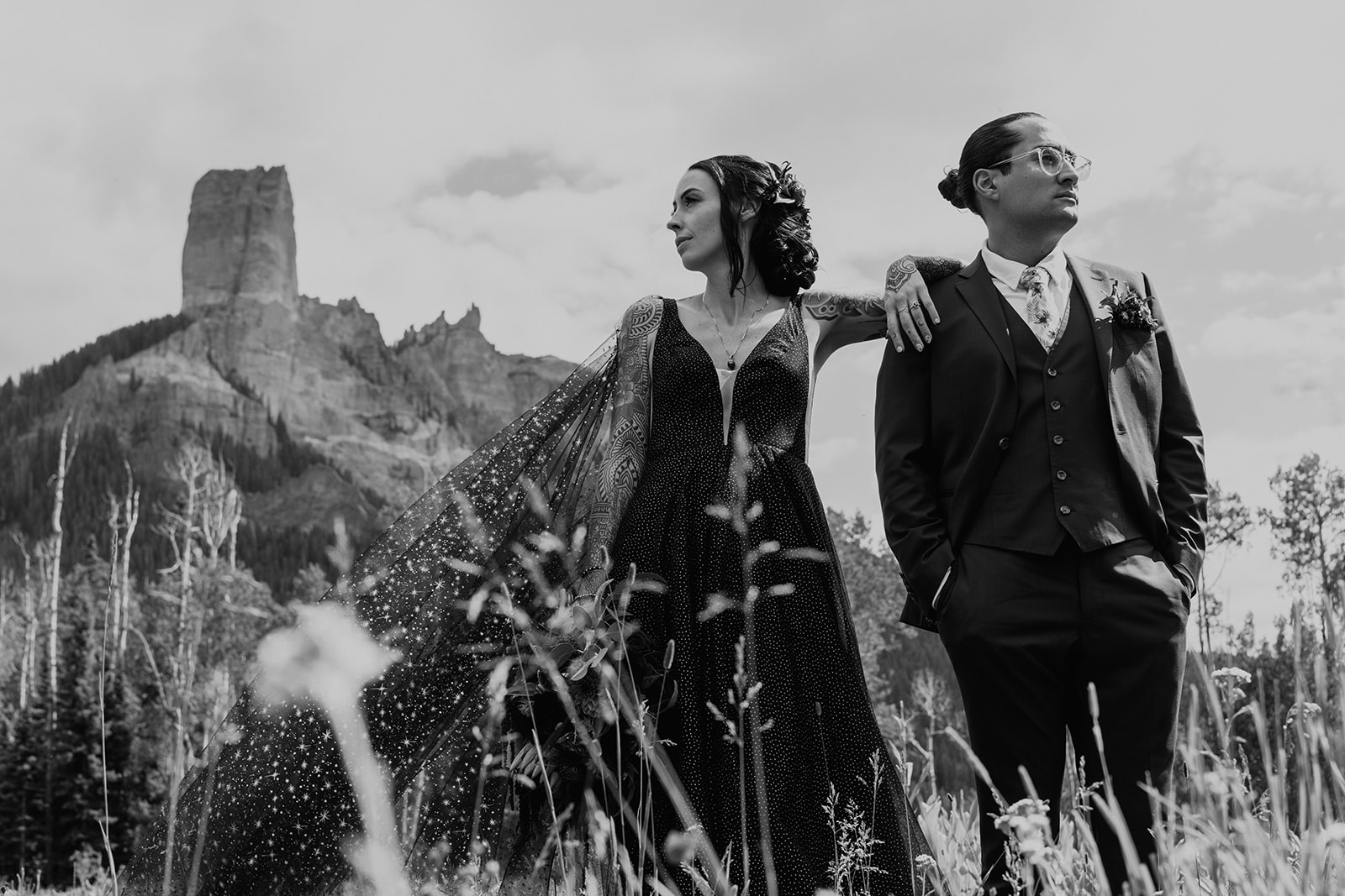 Black and white photo of bride and groom standing