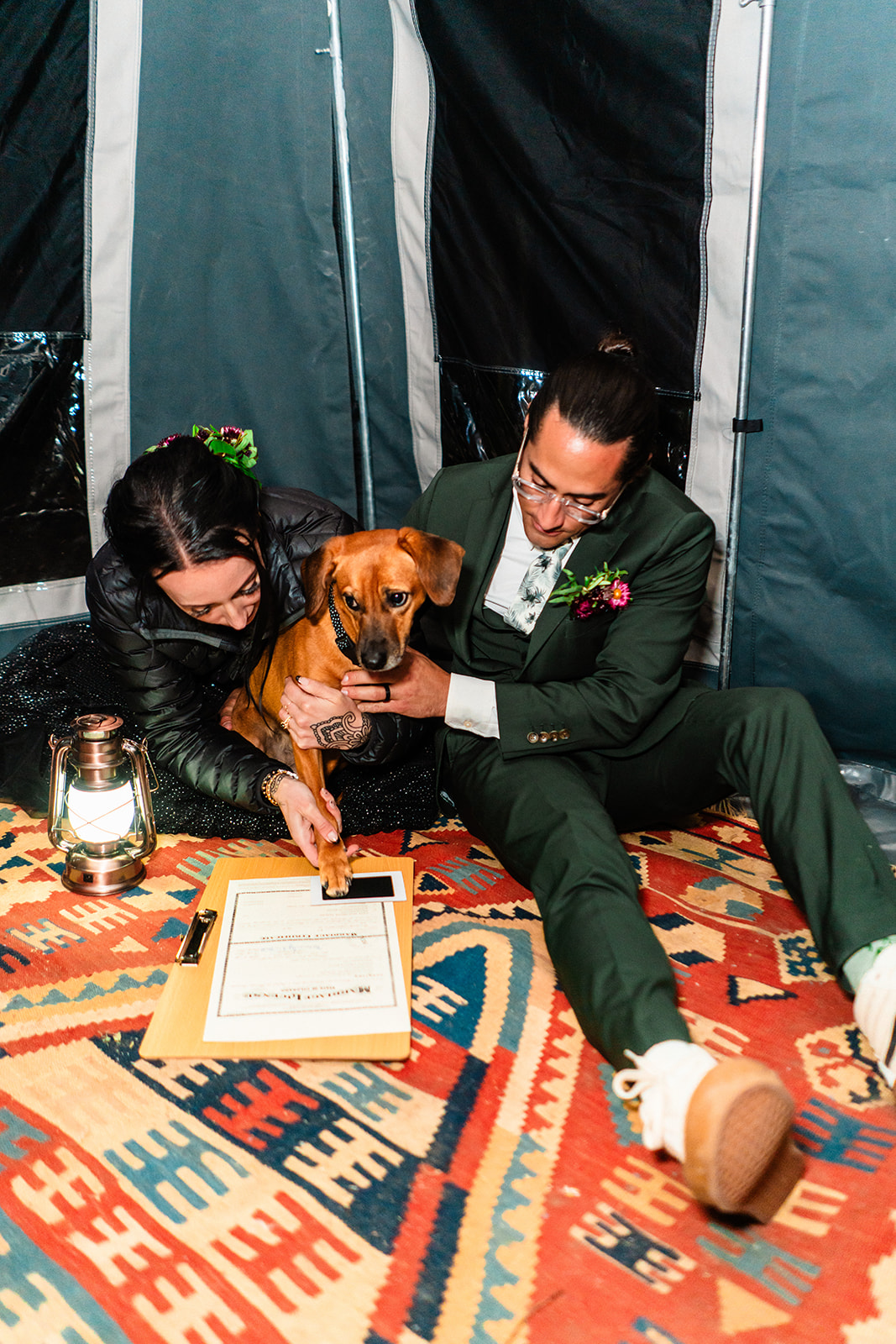 Black and white photo of bride and grooms pup signing their marriage license