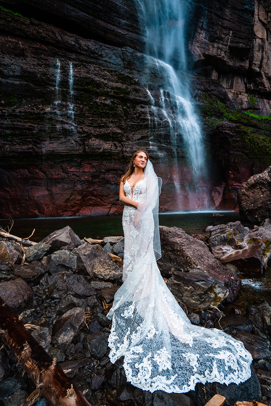 Stunning bride wearing a white A-line elopement dress in front of Bridal Veil Falls