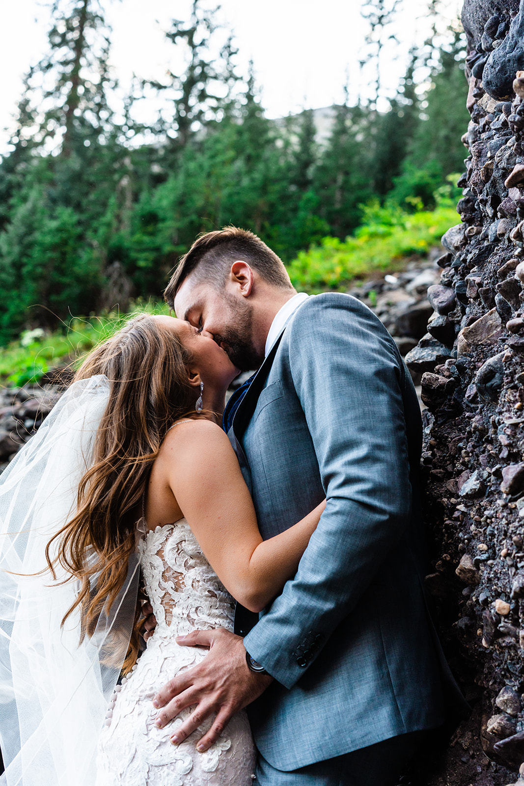 Bride and groom kissing in the mountains of Colorado