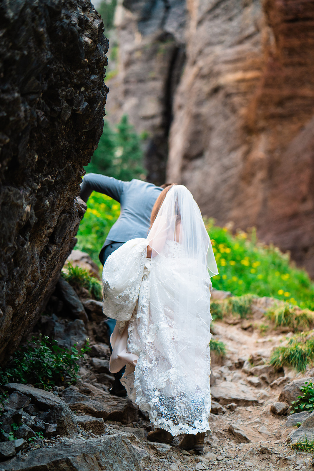 Bride and groom walking to Bridal Veil Falls