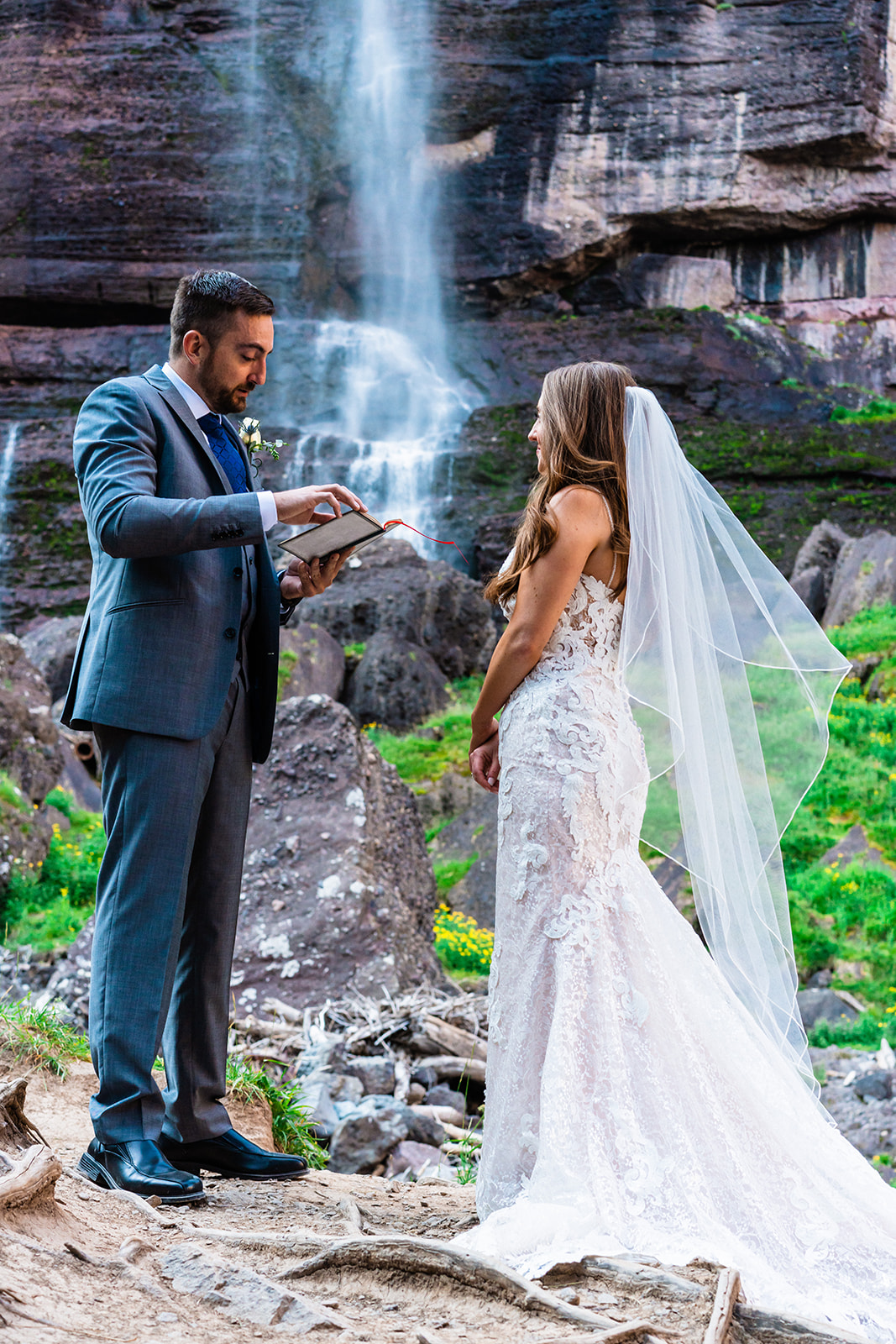 Bride and groom exchanging vows in front of Bridal Veil Falls